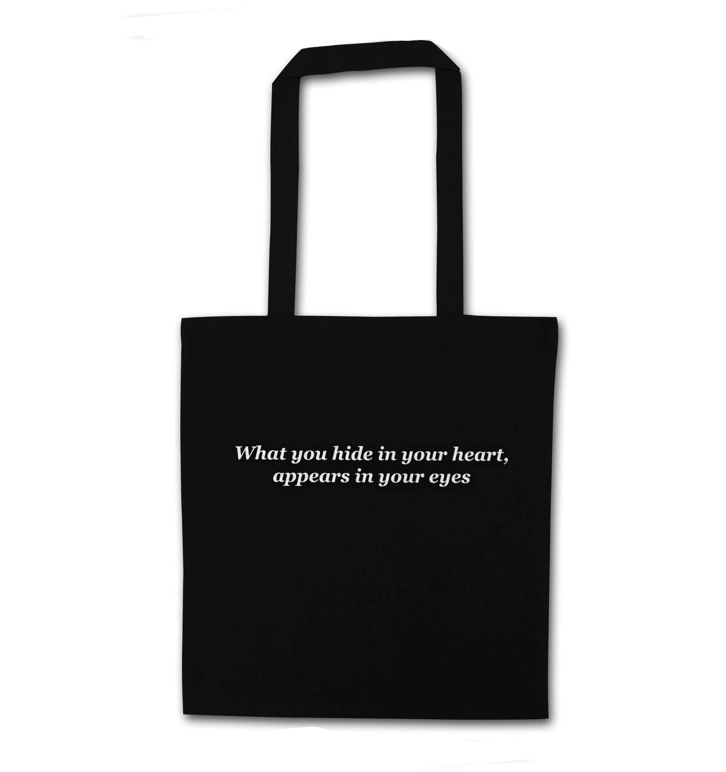 What you hide in your heart, appears in your eyes black tote bag