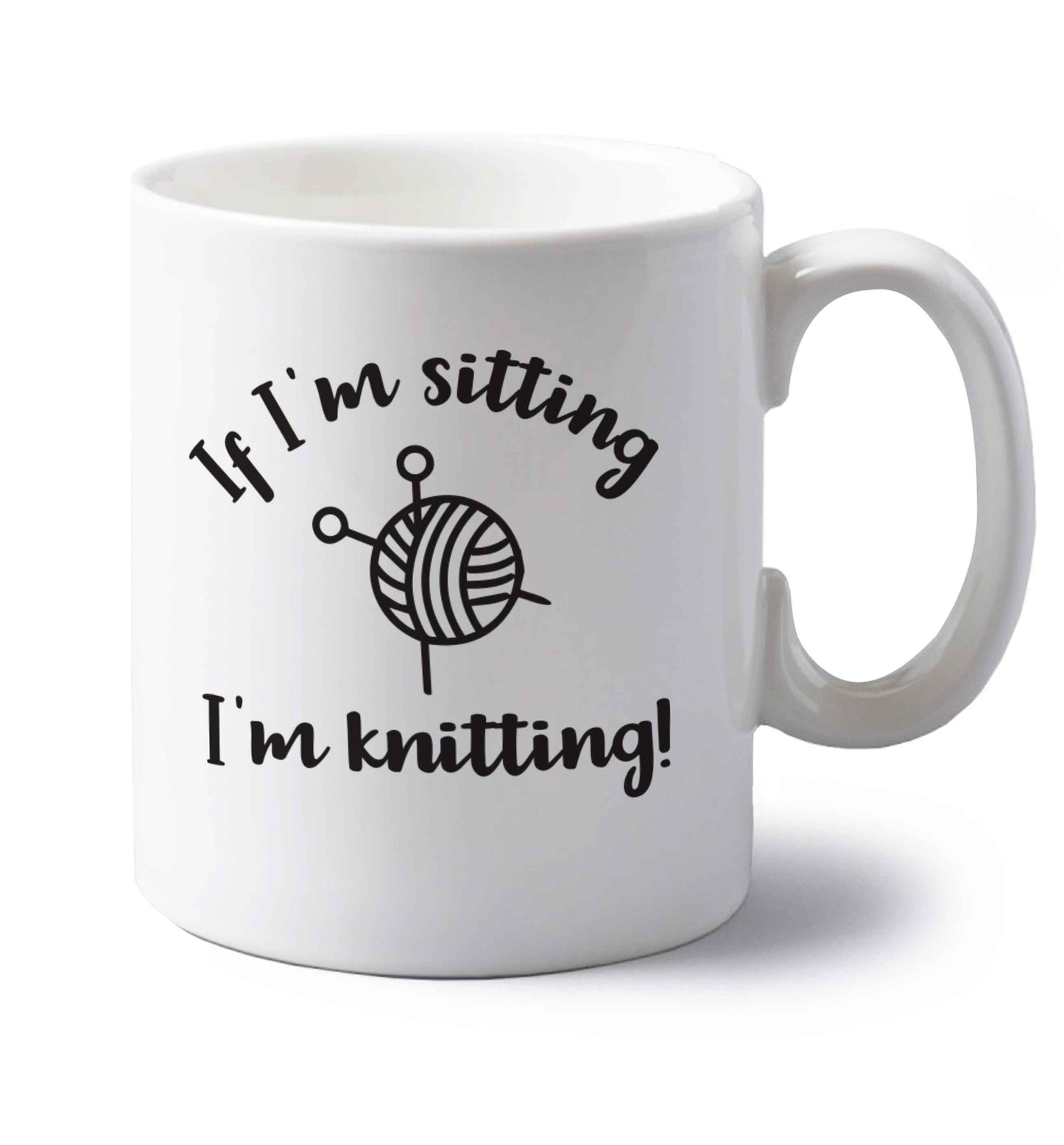 If I'm sitting I'm knitting left handed white ceramic mug