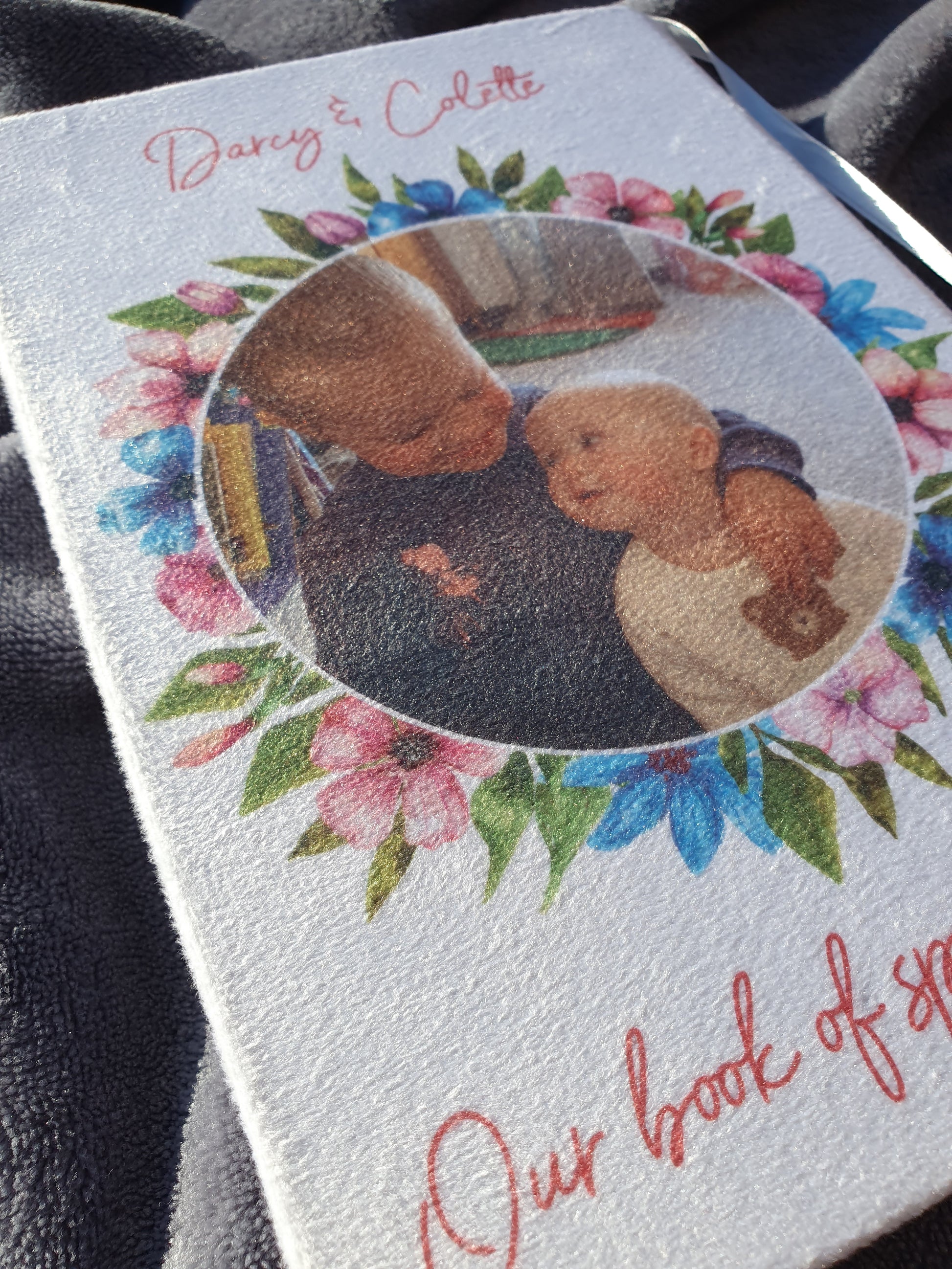 Close up of one of the books already printed to show what it will look like printed on the velvet. Image shows both photo and text printed on the cover