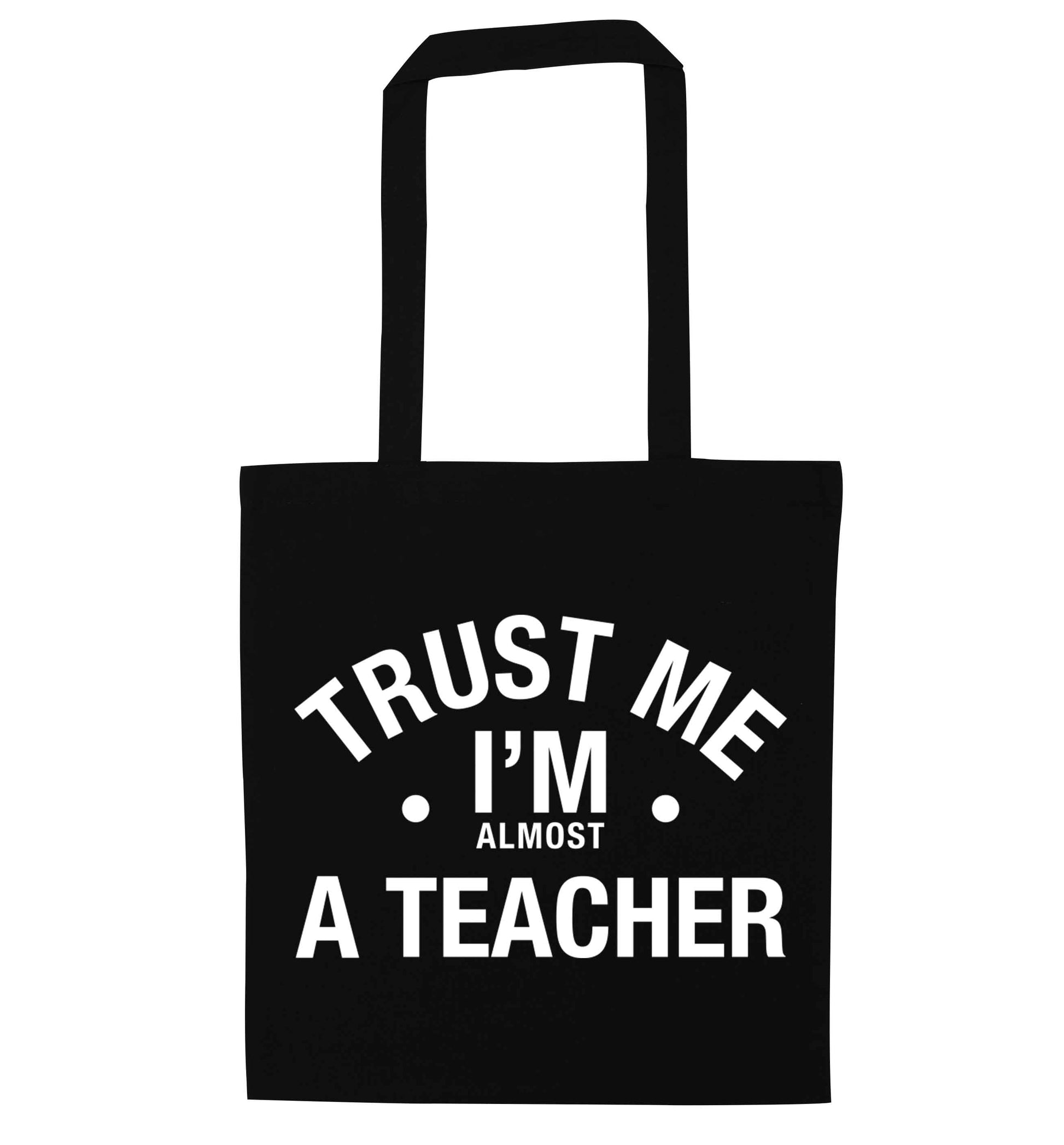 Trust me I'm almost a teacher black tote bag