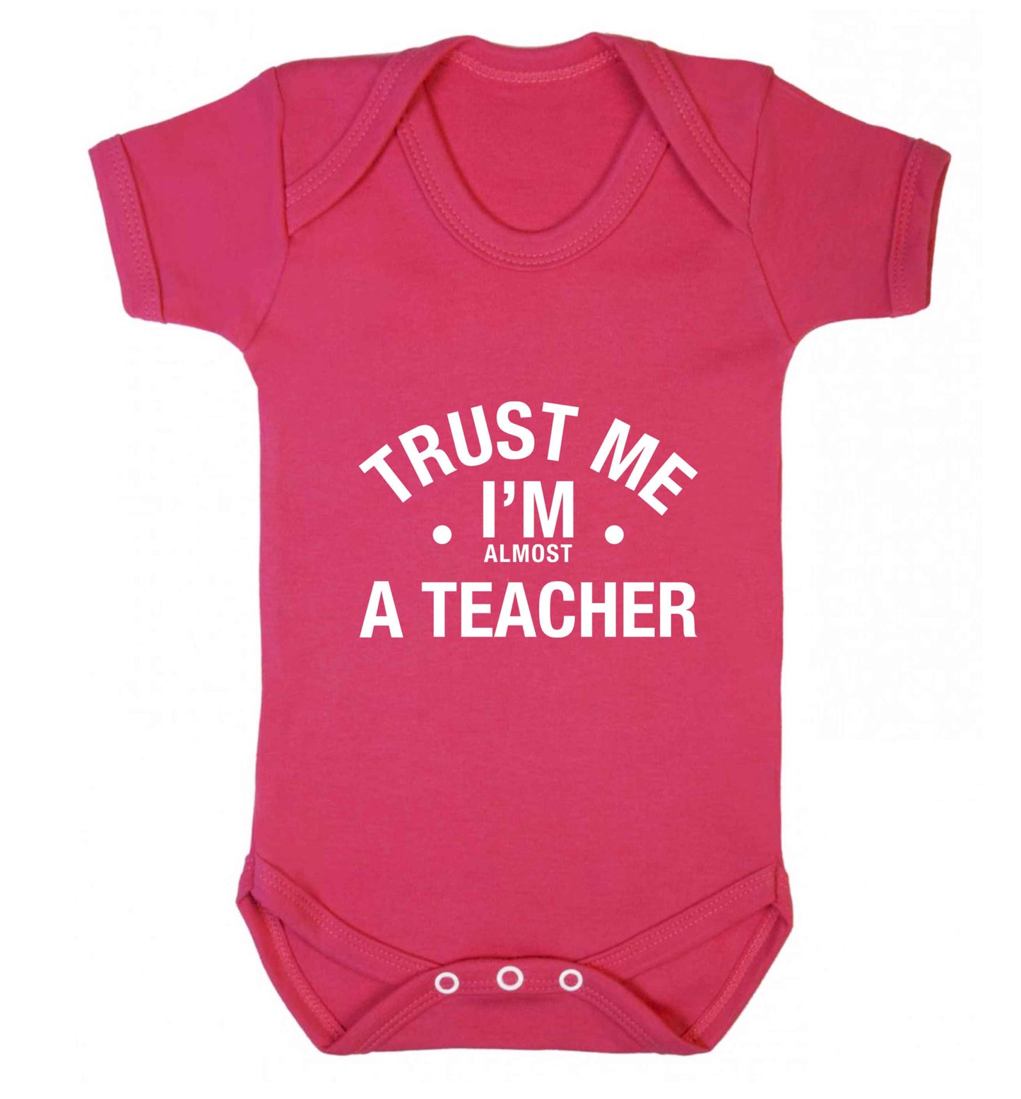 Trust me I'm almost a teacher baby vest dark pink 18-24 months