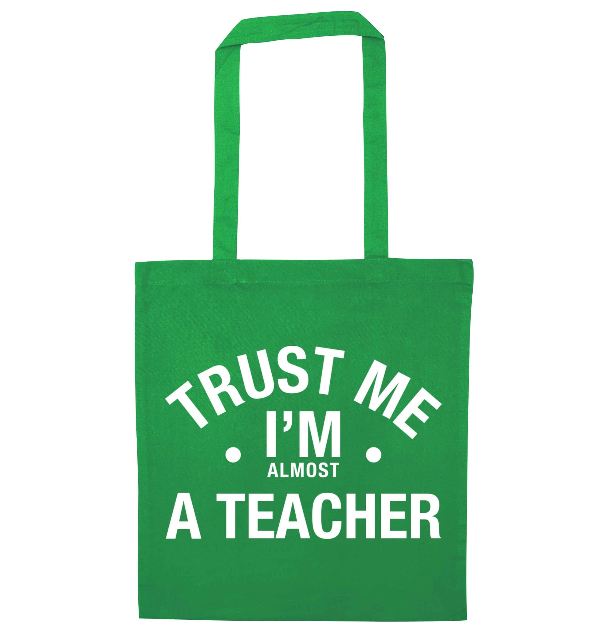 Trust me I'm almost a teacher green tote bag
