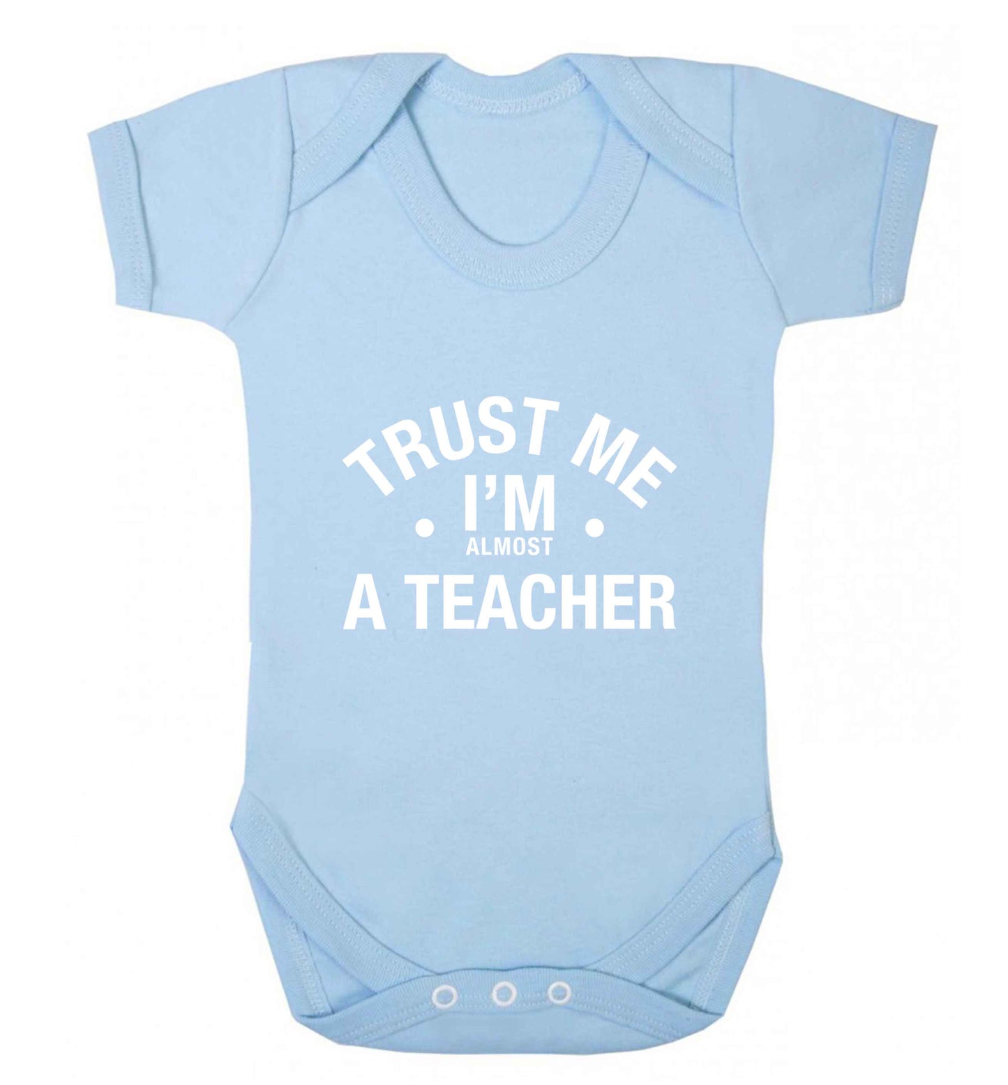 Trust me I'm almost a teacher baby vest pale blue 18-24 months