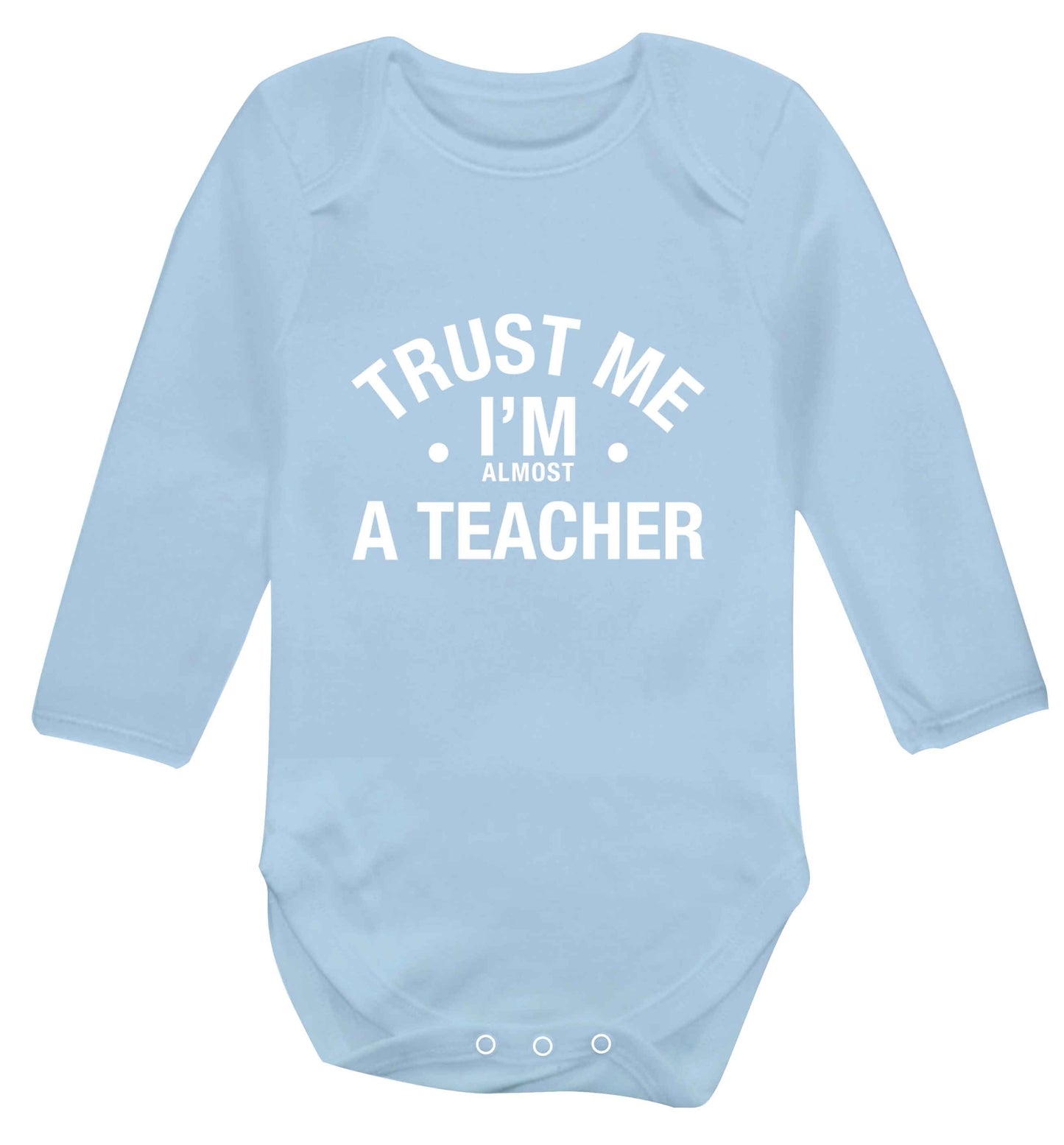 Trust me I'm almost a teacher baby vest long sleeved pale blue 6-12 months