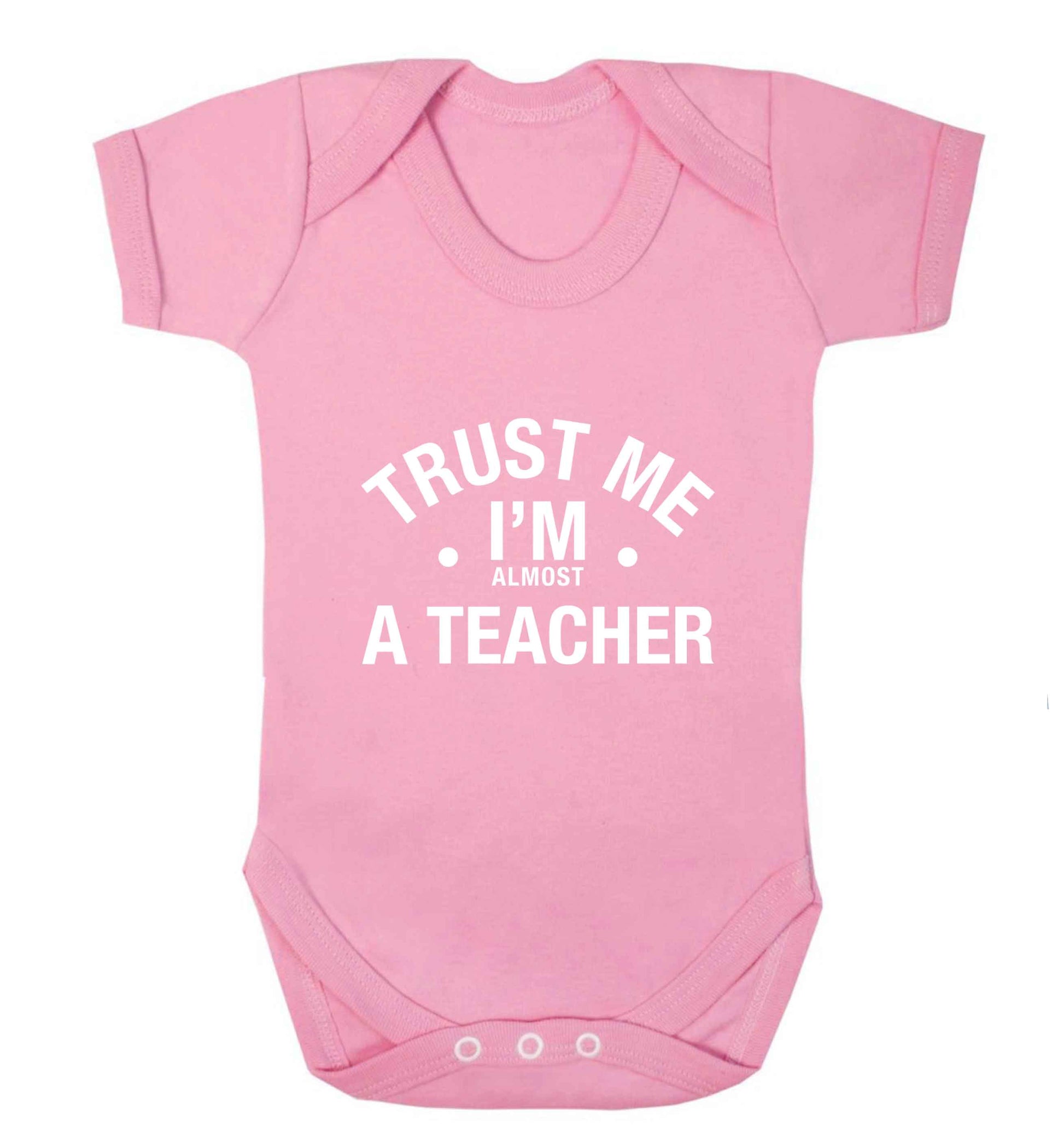 Trust me I'm almost a teacher baby vest pale pink 18-24 months