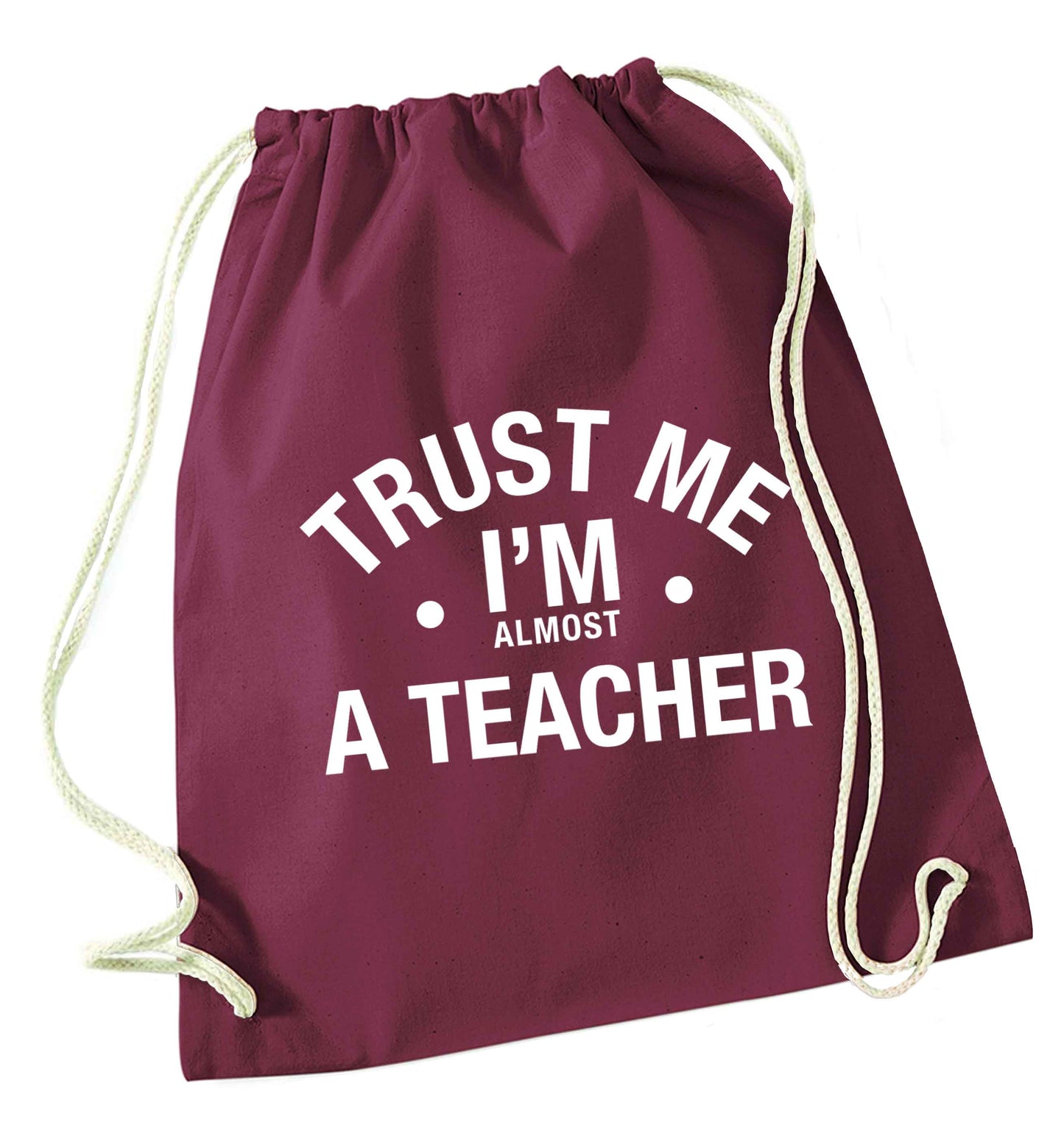 Trust me I'm almost a teacher maroon drawstring bag