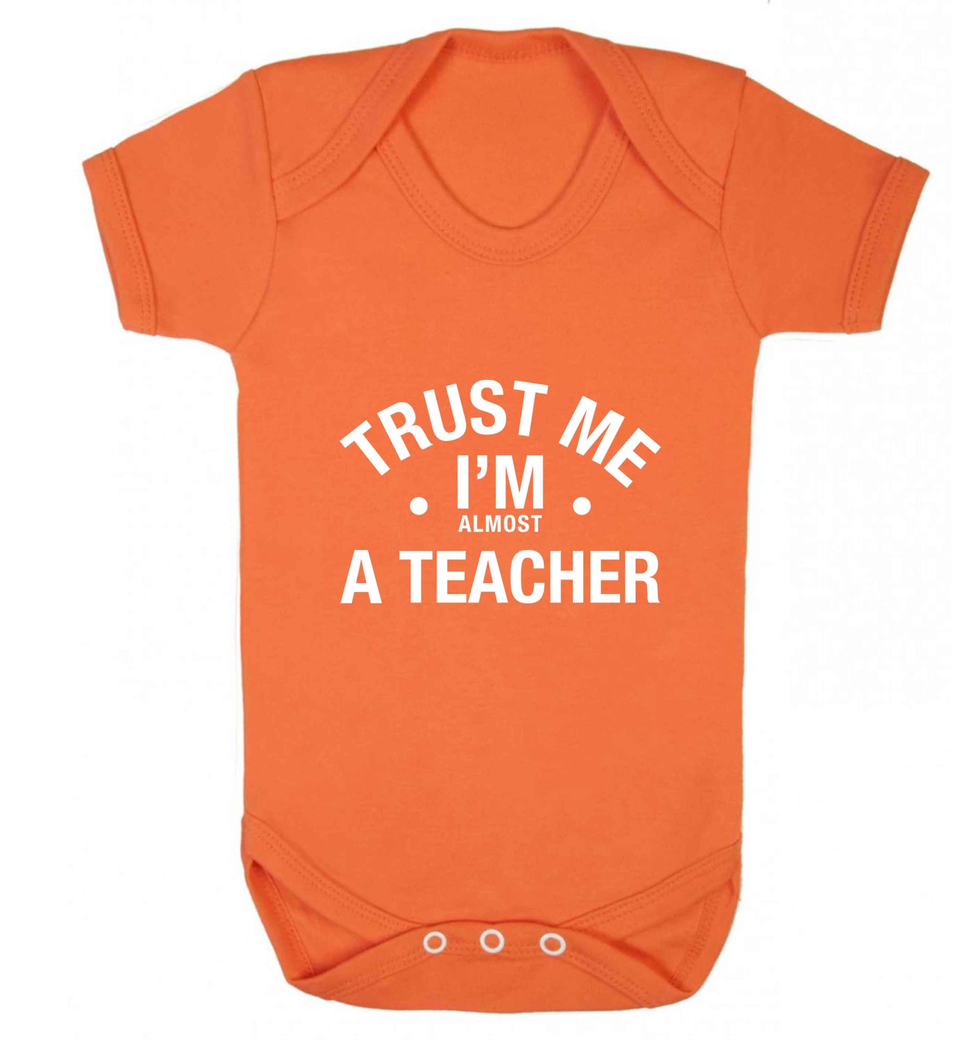 Trust me I'm almost a teacher baby vest orange 18-24 months