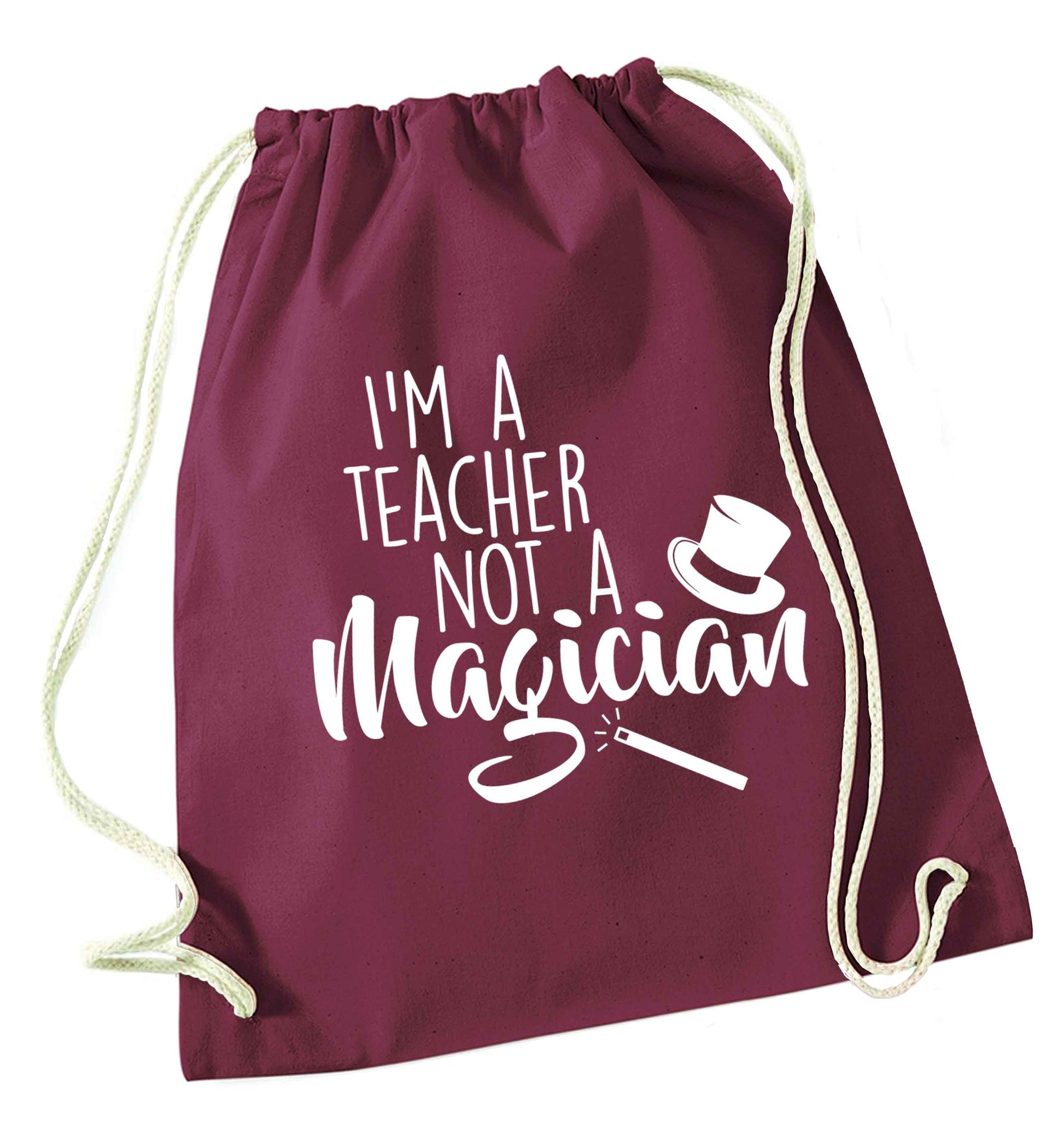 I'm a teacher not a magician maroon drawstring bag