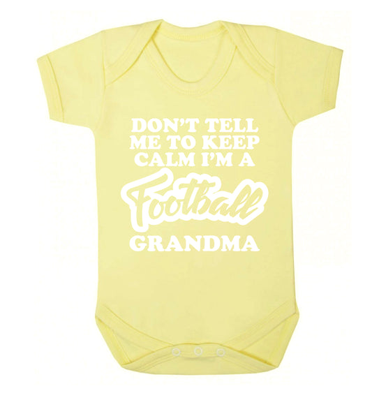 Don't tell me to keep calm I'm a football grandma Baby Vest pale yellow 18-24 months