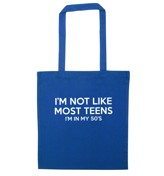 I'm not like most teens (I'm in my 50's) blue tote bag