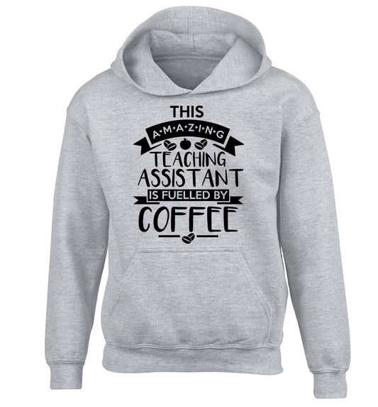 This amazing teaching assistant is fuelled by coffee children's grey hoodie 12-13 Years