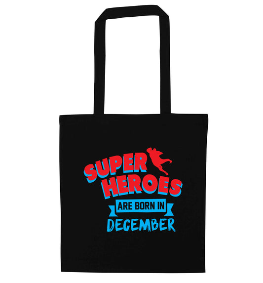 Superheroes are born in December black tote bag