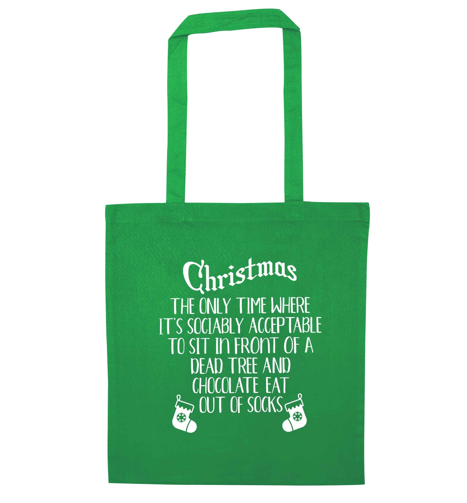 Christmas sit in front of a dead tree and eat chocolate out of socks green tote bag