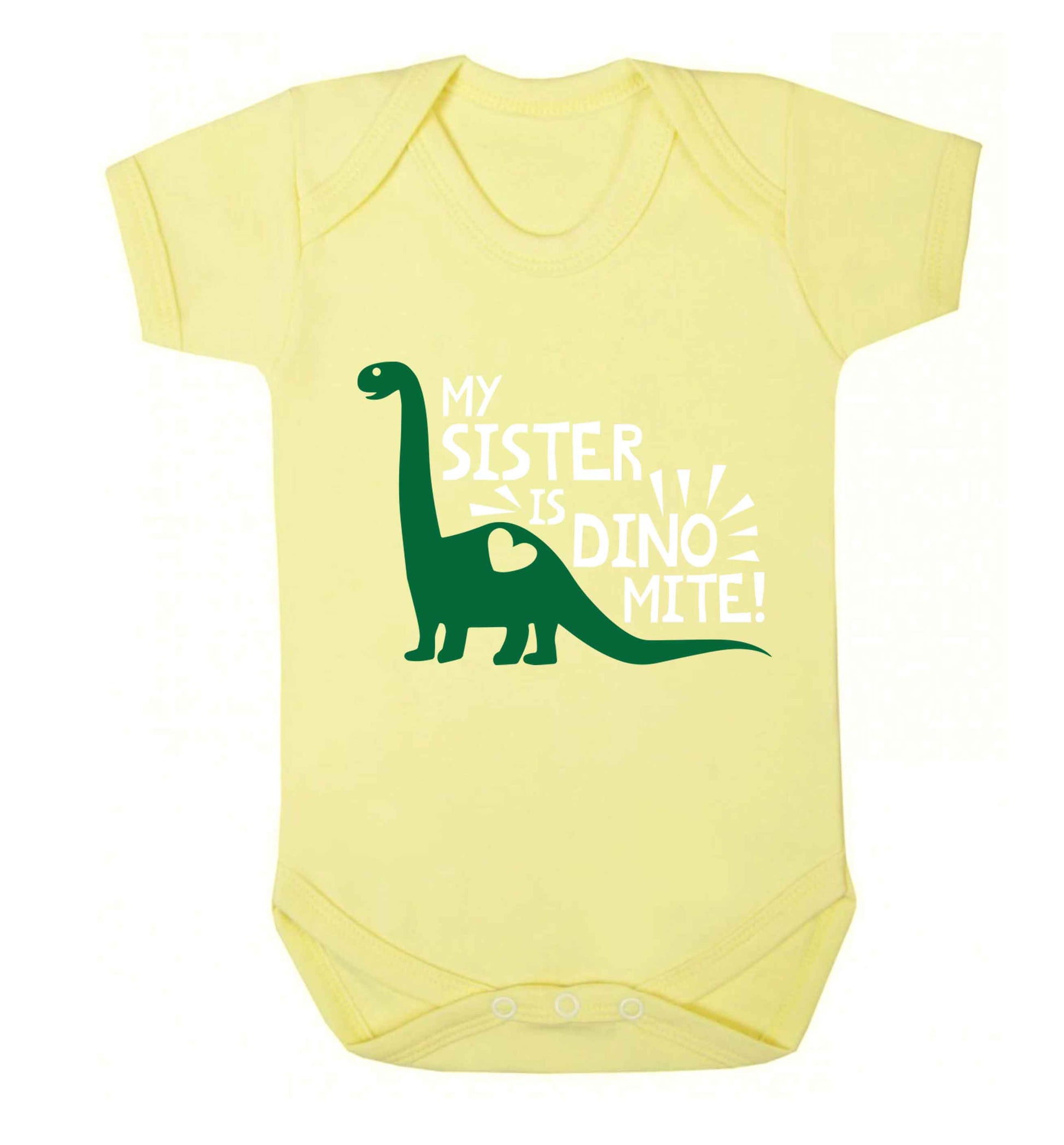 My sister is dinomite! Baby Vest pale yellow 18-24 months