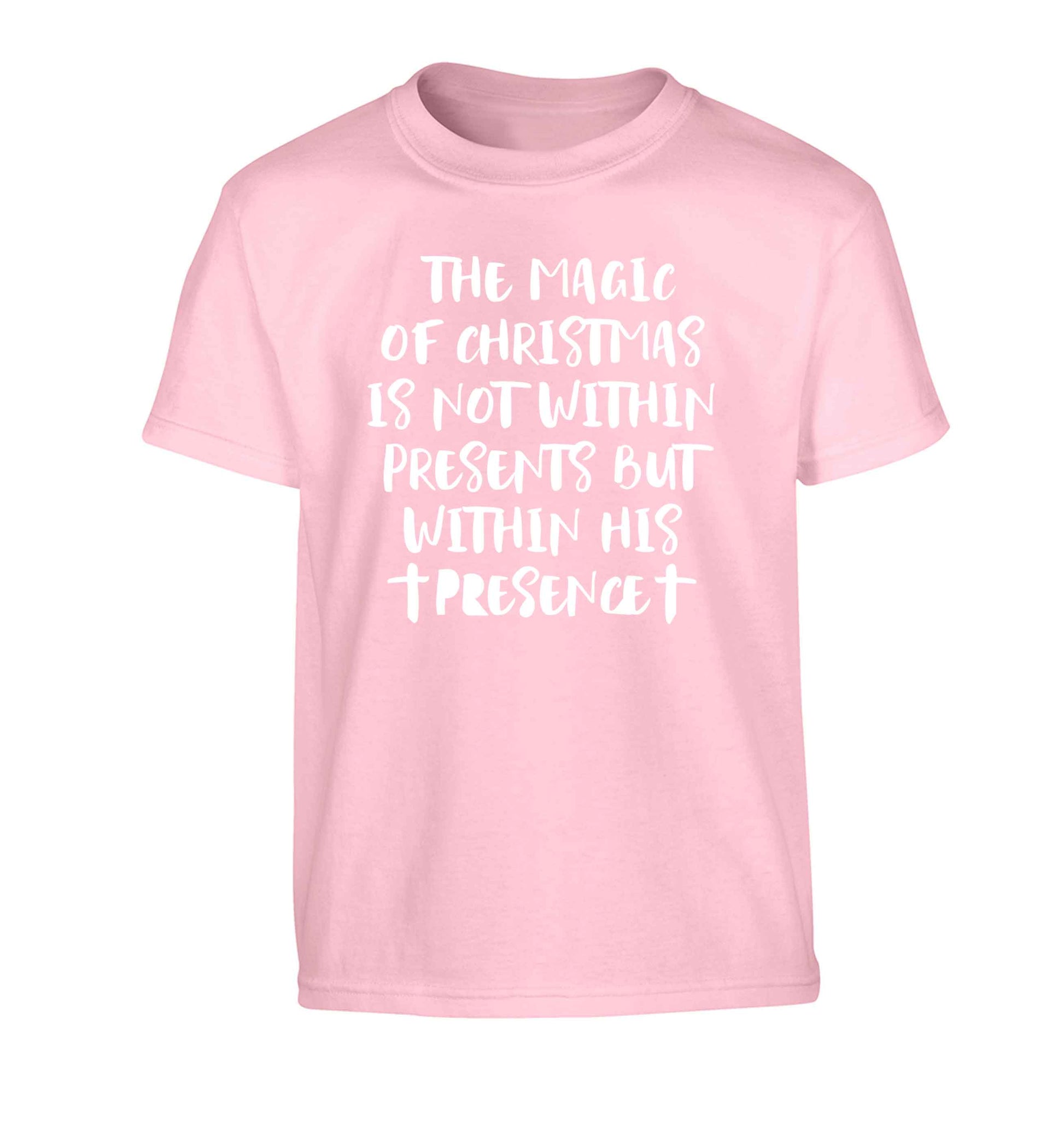 The magic of Christmas is not within presents but within his presence Children's light pink Tshirt 12-13 Years