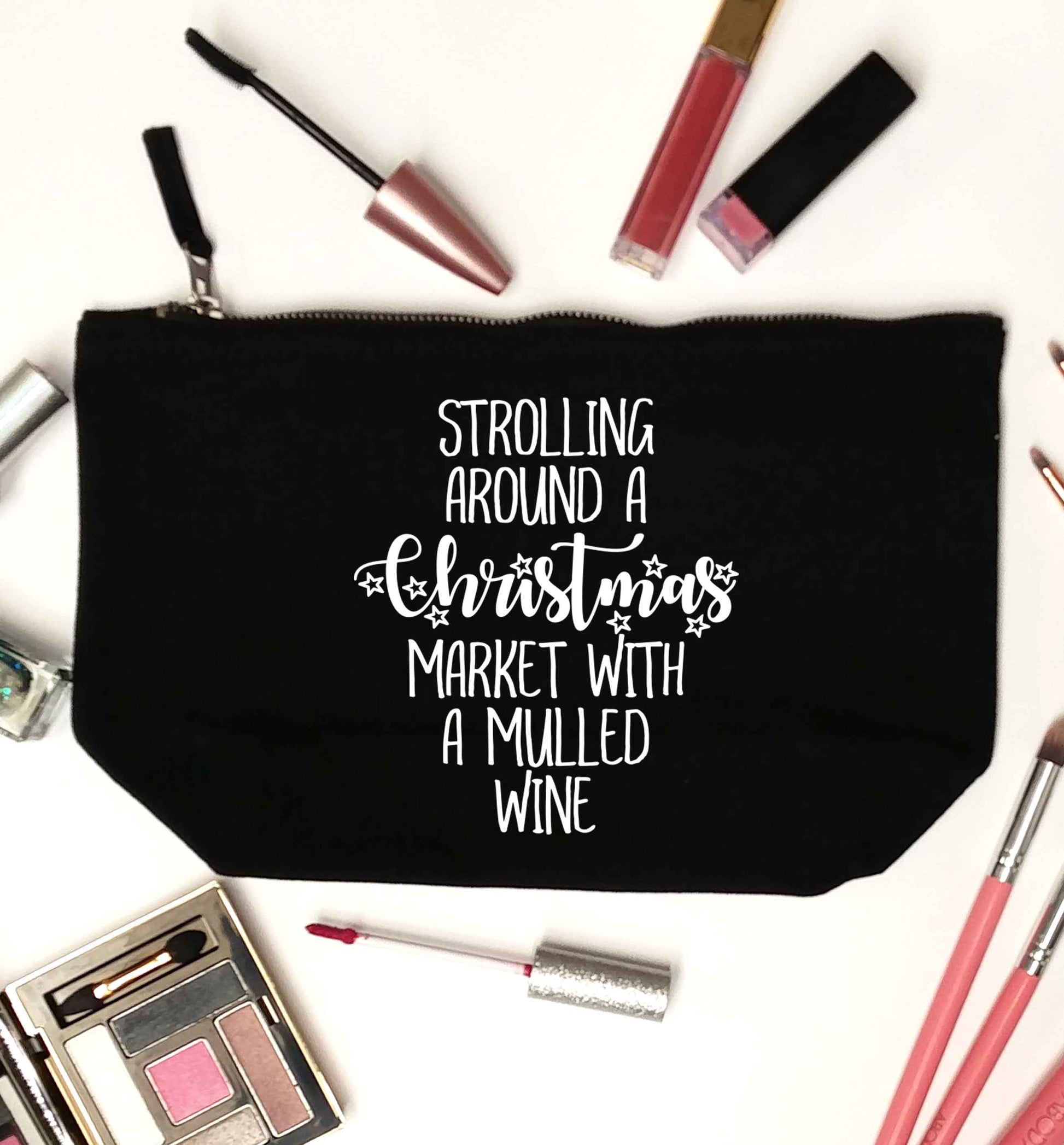Strolling around a Christmas market with mulled wine black makeup bag