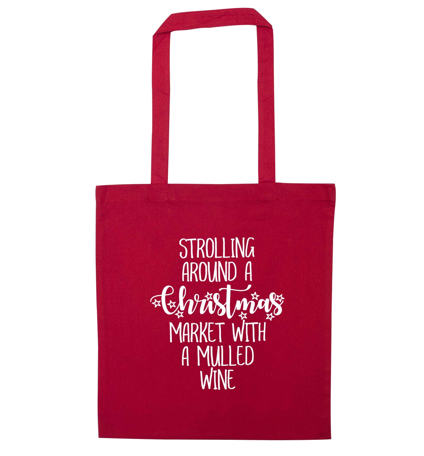 Strolling around a Christmas market with mulled wine red tote bag