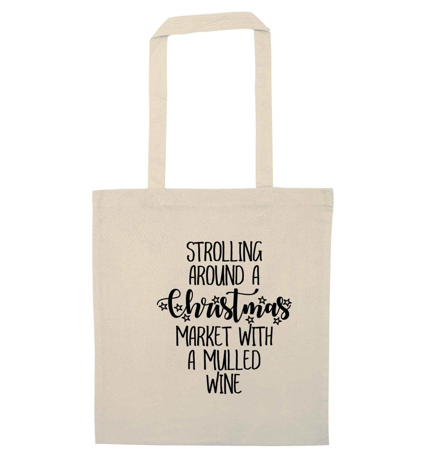 Strolling around a Christmas market with mulled wine natural tote bag