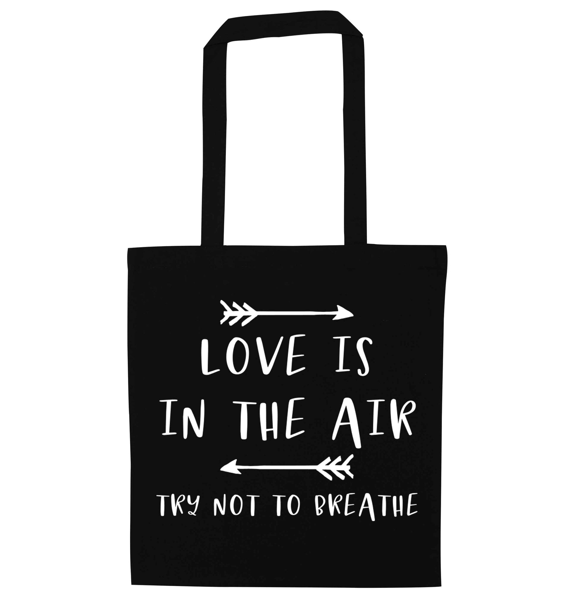 Love is in the air try not to breathe black tote bag