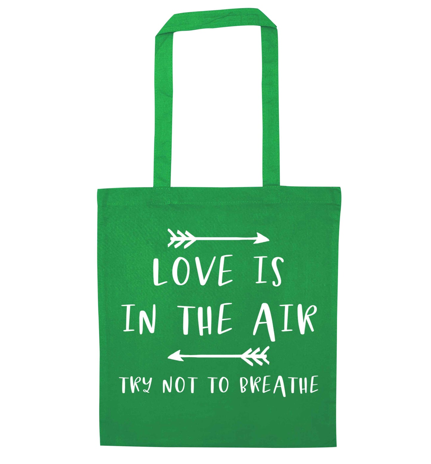 Love is in the air try not to breathe green tote bag