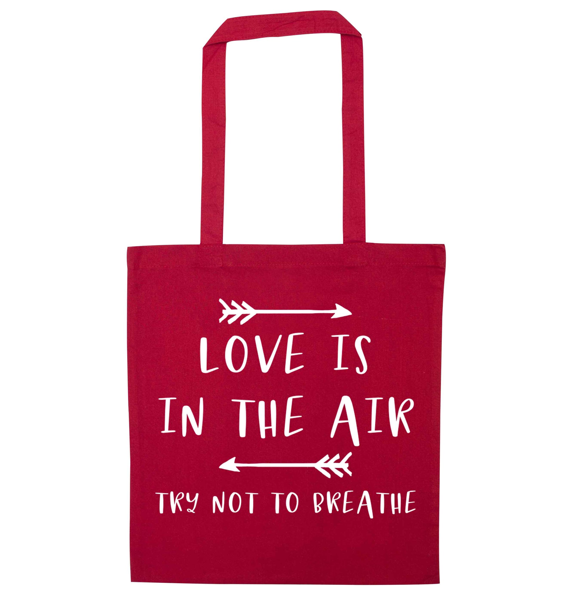 Love is in the air try not to breathe red tote bag