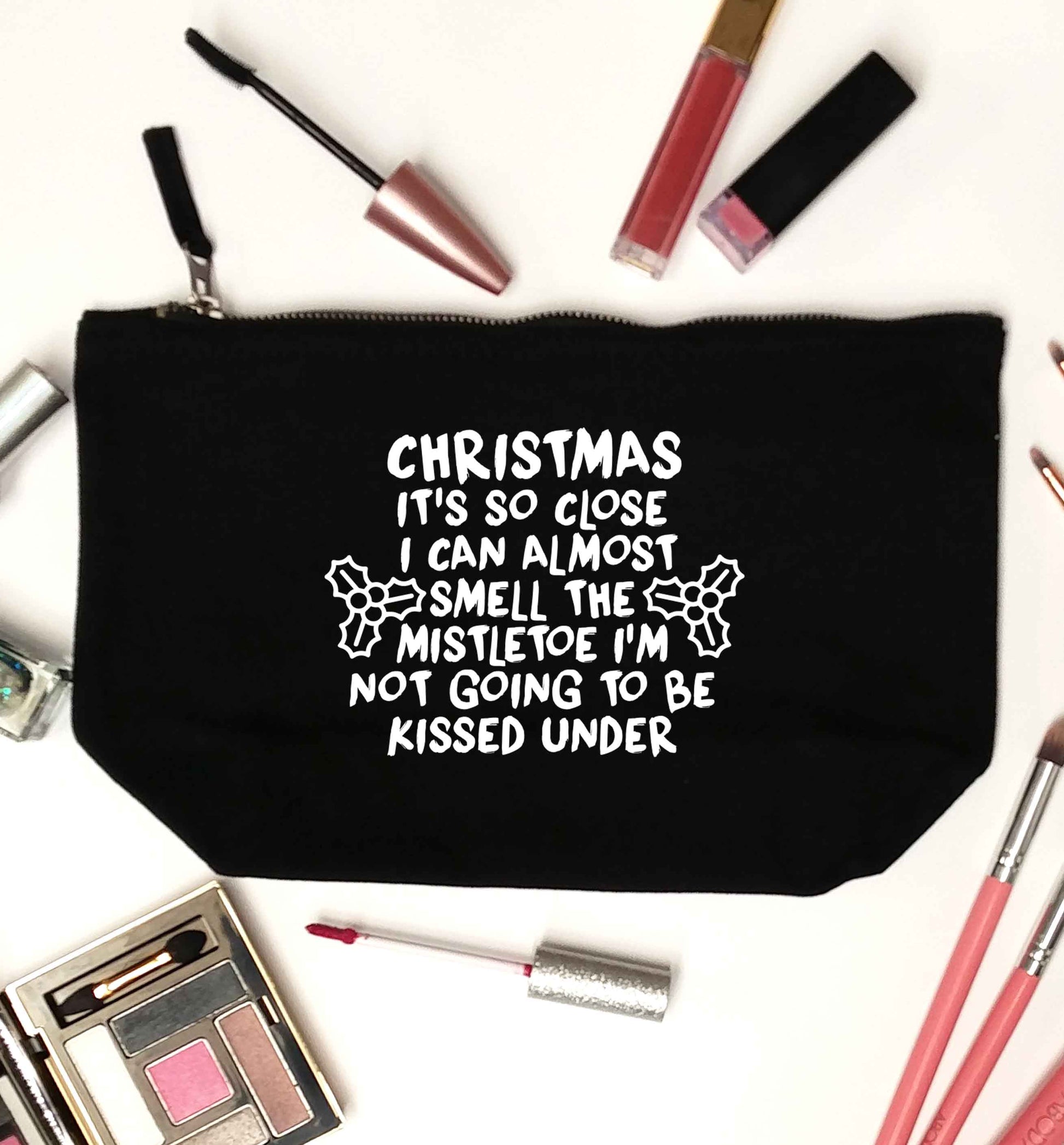 Christmas it's so close I can almost smell the misteltoe I'm not going to be kissed under black makeup bag