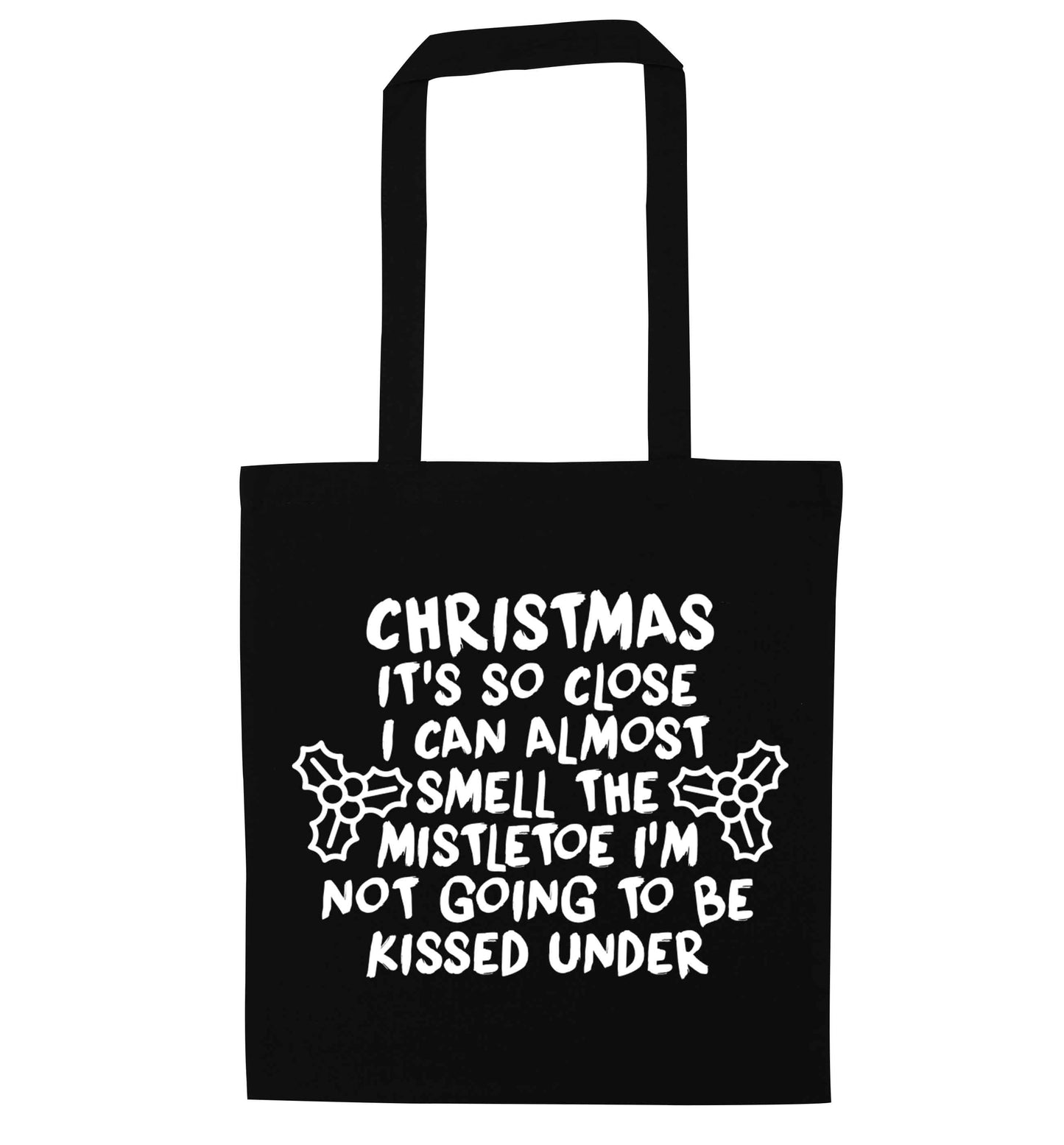 Christmas it's so close I can almost smell the misteltoe I'm not going to be kissed under black tote bag