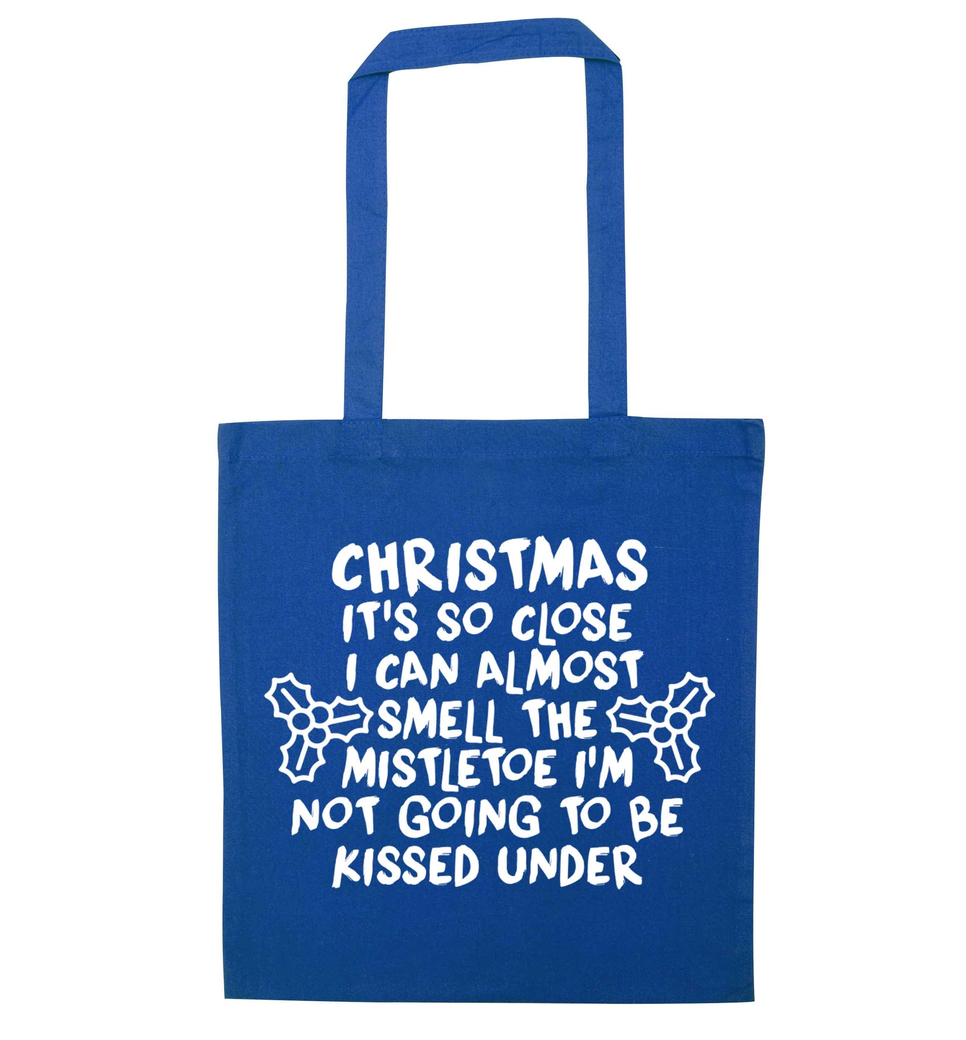 Christmas it's so close I can almost smell the misteltoe I'm not going to be kissed under blue tote bag