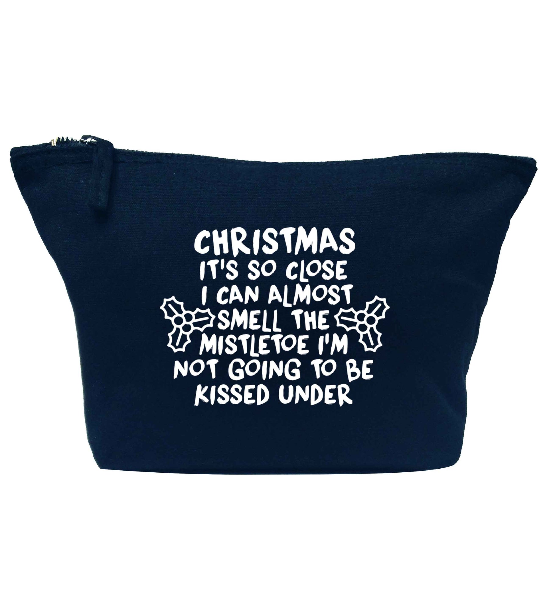 Christmas it's so close I can almost smell the misteltoe I'm not going to be kissed under navy makeup bag