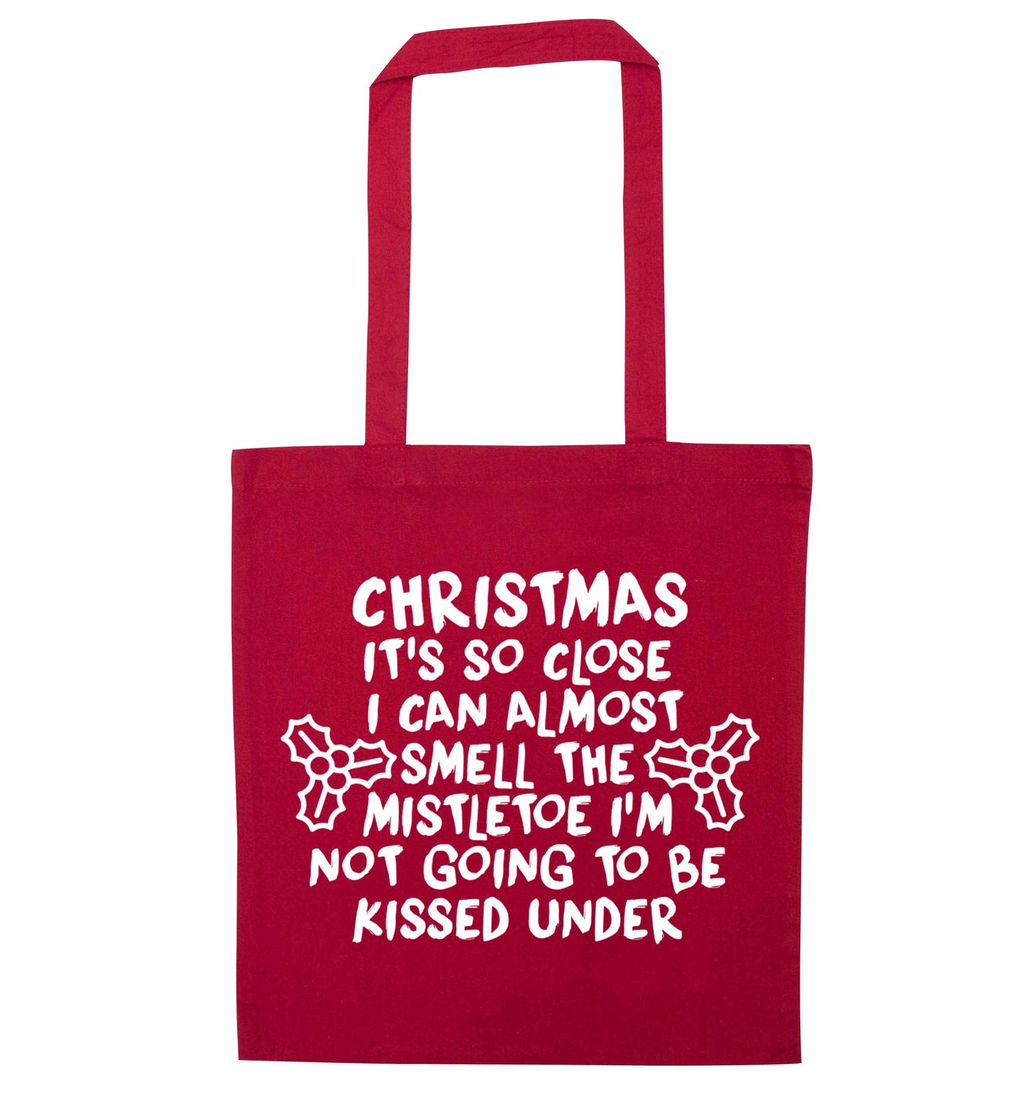 Christmas it's so close I can almost smell the misteltoe I'm not going to be kissed under red tote bag