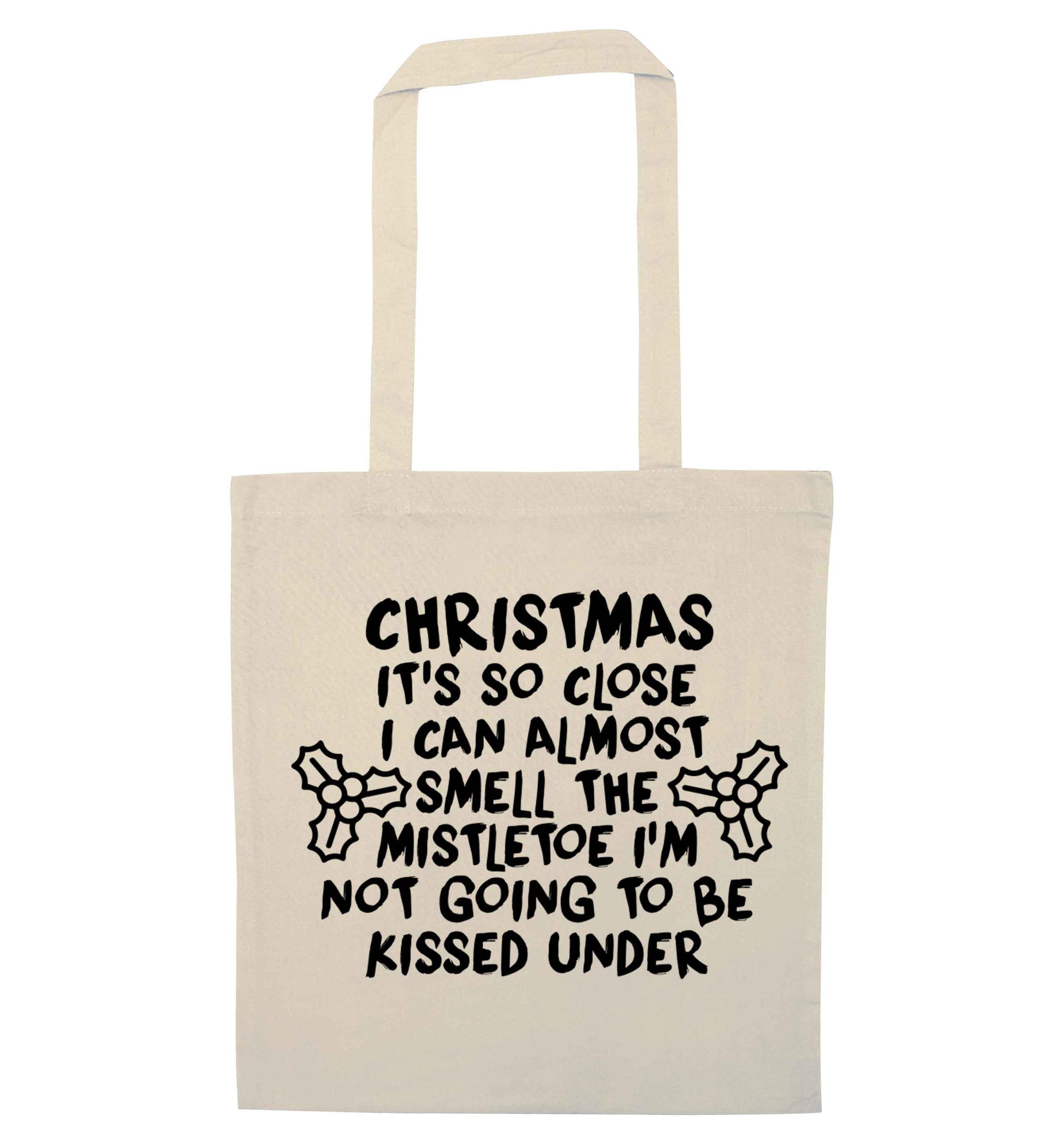 Christmas it's so close I can almost smell the misteltoe I'm not going to be kissed under natural tote bag