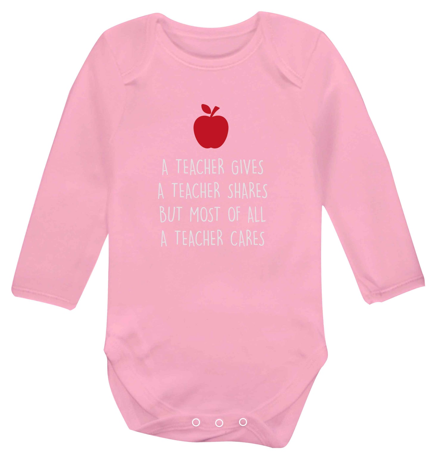 A teacher gives a teacher shares but most of all a teacher cares baby vest long sleeved pale pink 6-12 months