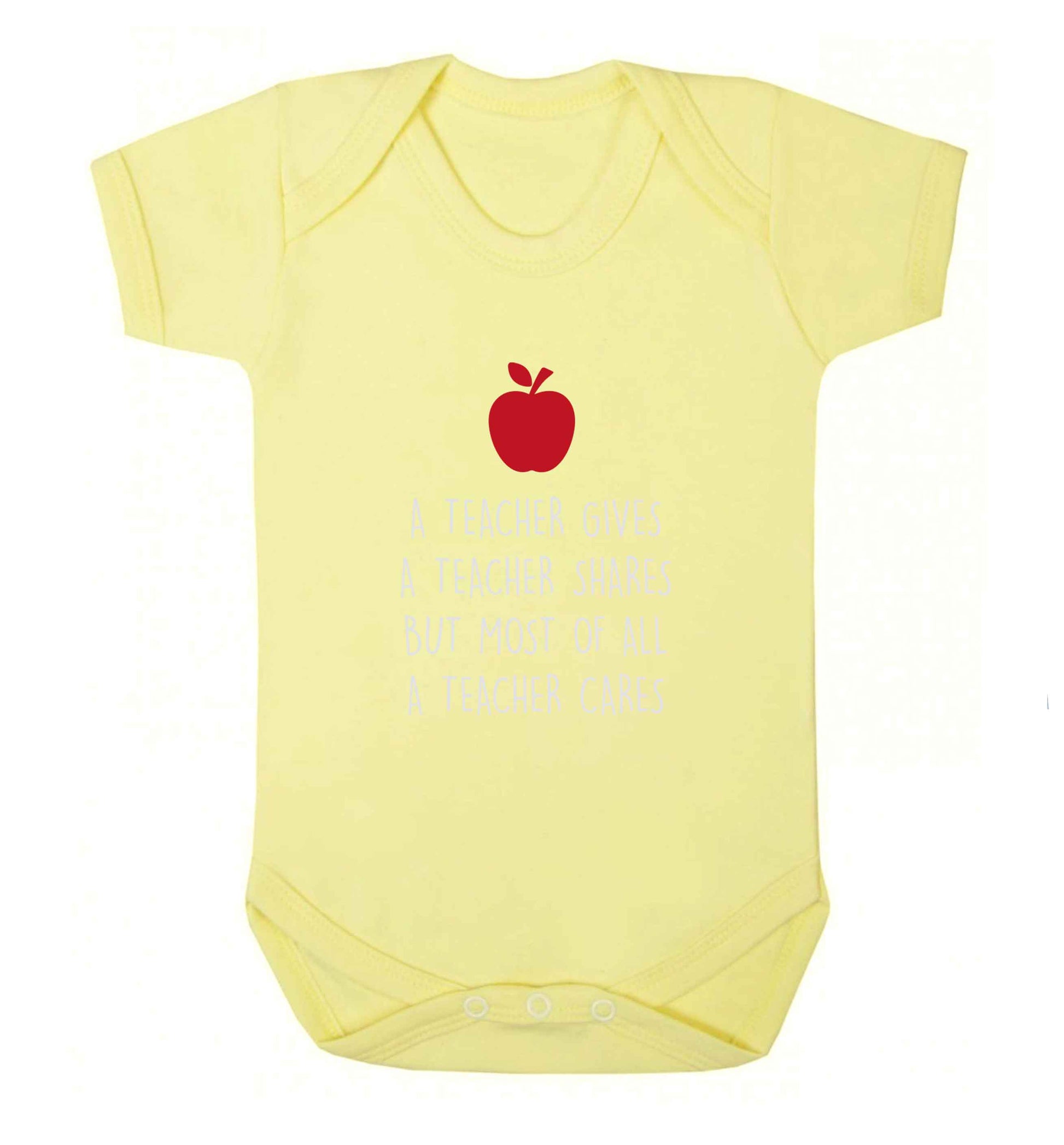 A teacher gives a teacher shares but most of all a teacher cares baby vest pale yellow 18-24 months